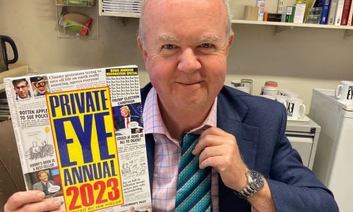 Signed Private Eye Annual and a tie as worn by Ian Hislop